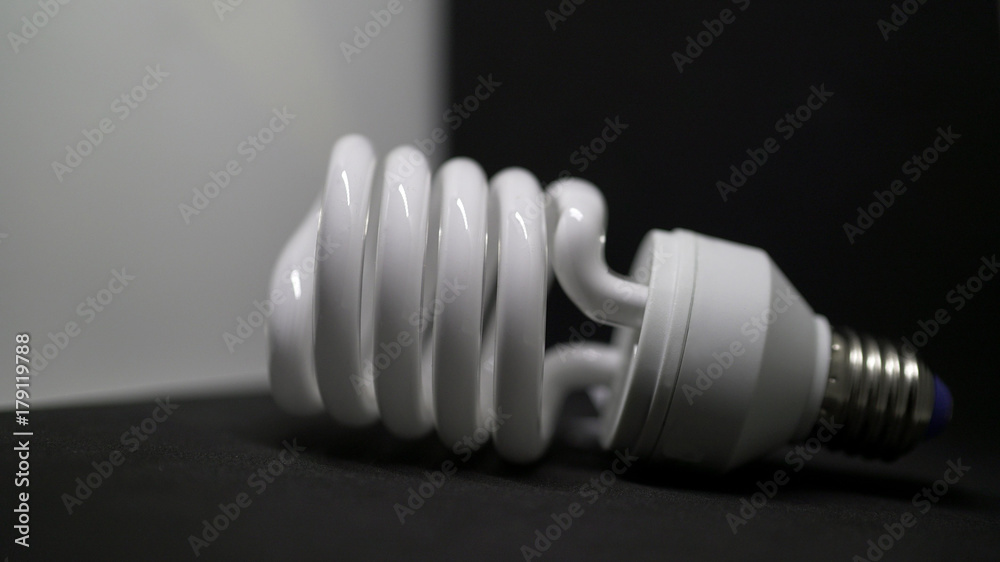 spiral light bulb on a black background. spiral light bulb on a black background.