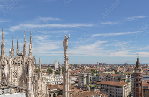 White marble statues on the roof of famous Cathedral Duomo di Milano on piazza in Milan, Italy © Anatoly