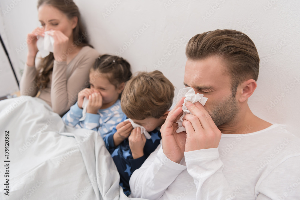 family blowing noses in napkins family blowing noses in napkins
