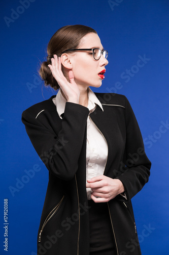 young brunette woman in a jacket with red lipstick on the lips