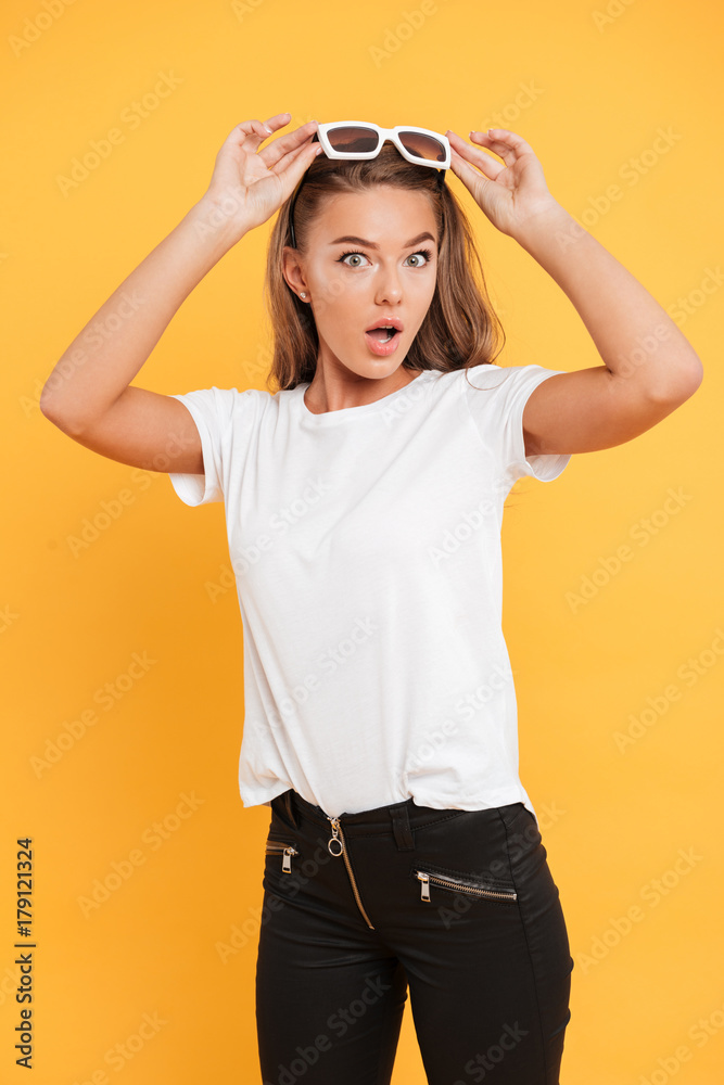 Shocked pretty young woman standing isolated Shocked pretty young woman standing isolated