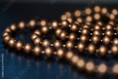 Long brown necklace on a dark background