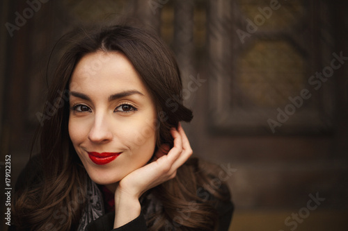 young attractive woman posing against vintage wooden door