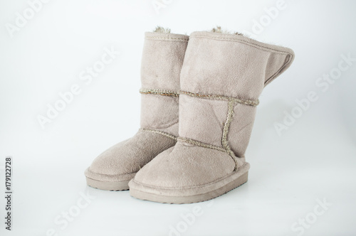 Girl's pair of wool boot for winter on white background © Prajukpunt