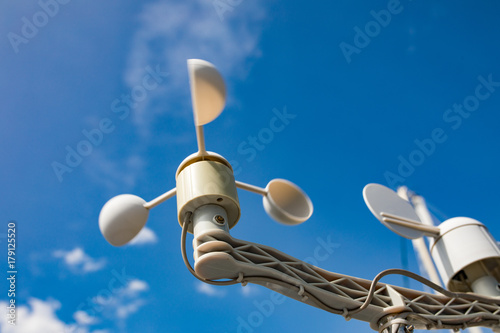 Sail boat anemometer on the blue sky background. Yacht equipment, sailors world. photo