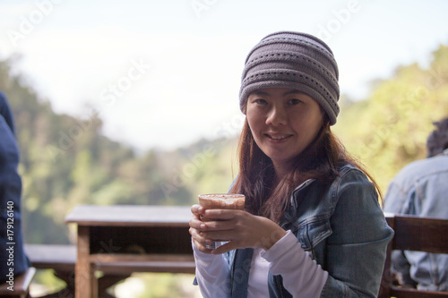 Young girl traveler drink hot tea or coffee .