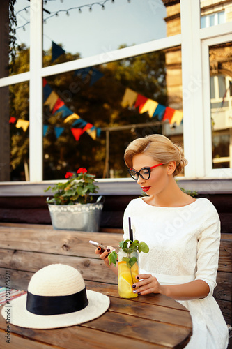 Sexy blonde in retro look resting in cafe
