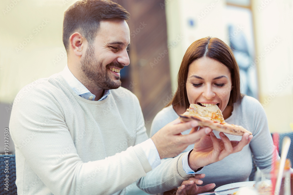 Couple eating pizza snack outdoors. Couple eating pizza snack outdoors.