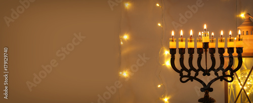 Low key image of jewish holiday Hanukkah background with menorah (traditional candelabra)