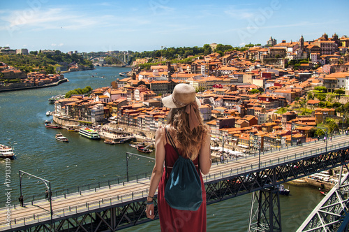 Yougn woman in red dress traveling in Portugal