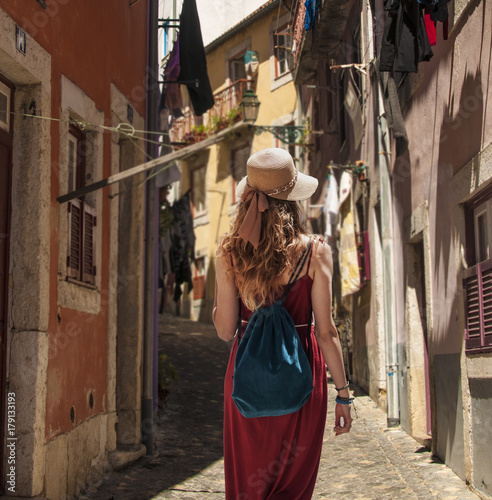 Yougn woman in red dress traveling in Portugal