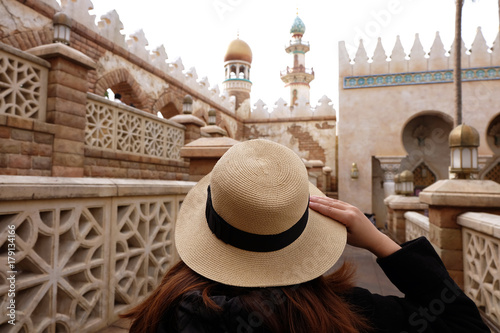 Woman tourist is traveling into Mosque Masjid.