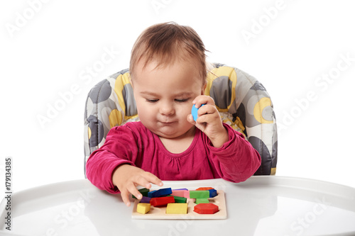 Child little girl learning to use colorful logic game isolated on white background