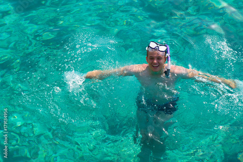 Man with snorkeling mask for diving swimming in the Indian ocean at Maldivian island. Man is snorkeling in the tropical sea. Happy man Enjoying snorkelling with clear blue water in the Maldives ocean. © Beetroot Studio