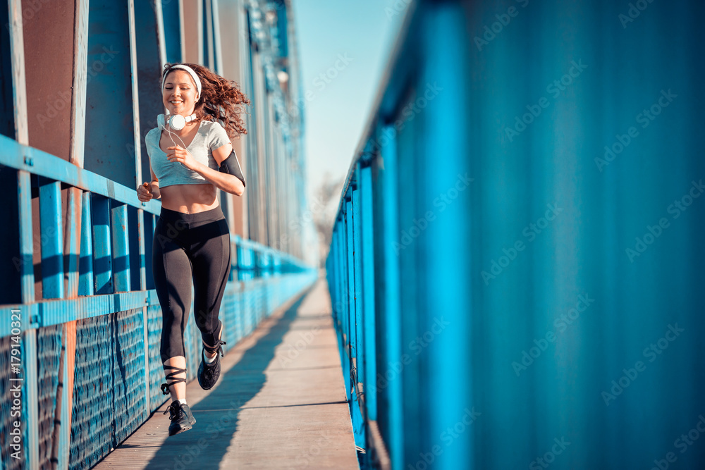 Young Fitness Woman Running over Bridge Young Fitness Woman Running over Bridge