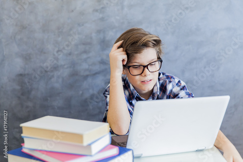Teenage boy working on lapt...