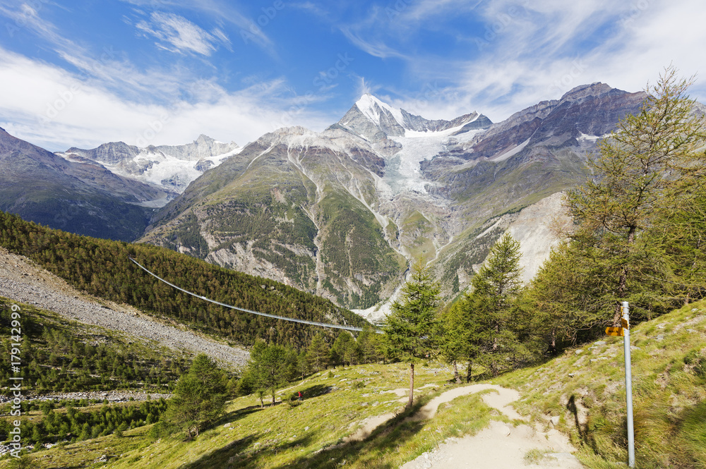 Charles Kuonen Suspension Bridge, the world's longest for pedestrians at 494m on the Europaweg trail, and Weisshorn, 4506m, Randa, Zermatt, Valais, Swiss Alps Charles Kuonen Suspension Bridge, the world's longest for pedestrians at 494m on the Europaweg trail, and Weisshorn, 4506m, Randa, Zermatt, Valais, Swiss Alps