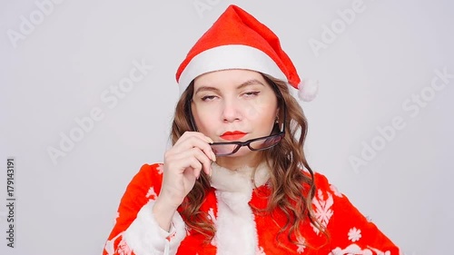 Cute Woman wearing Santa Claus hat and glasses photo