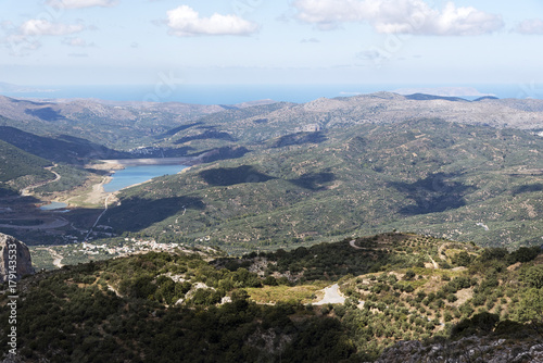 View across mountains of a water reservoir from the mountain road at Ano Kera, Lasithi, Crete, Greece. October 2017