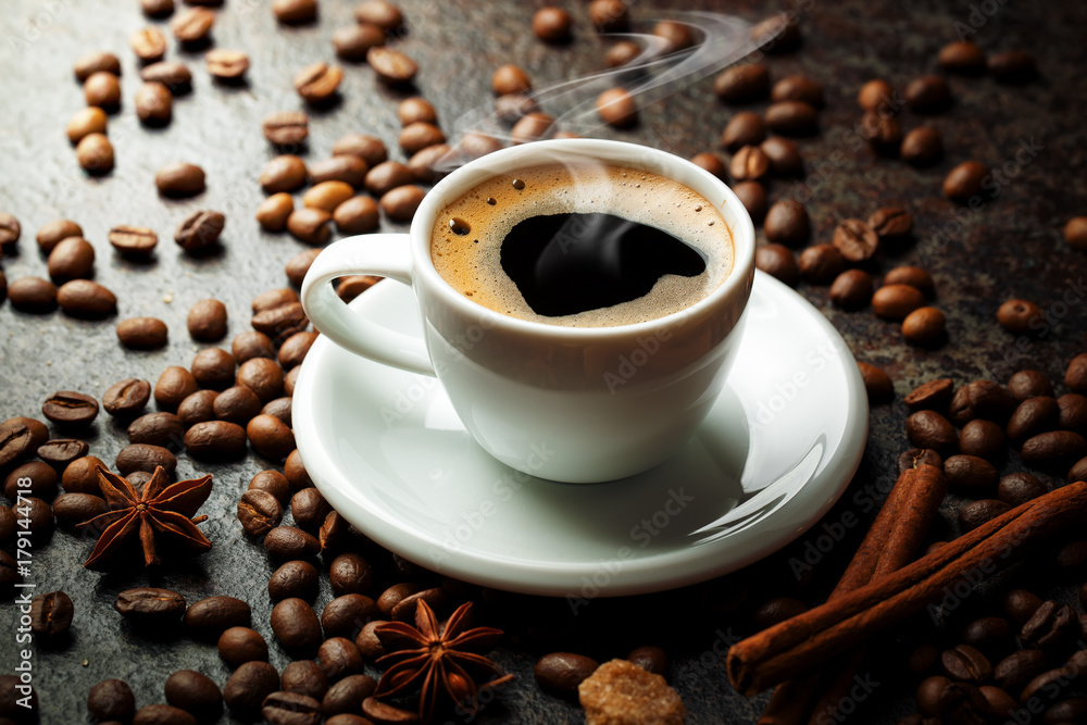 Black coffee in a cup on the table in a composition with coffee accessories on an old background Black coffee in a cup on the table in a composition with coffee accessories on an old background