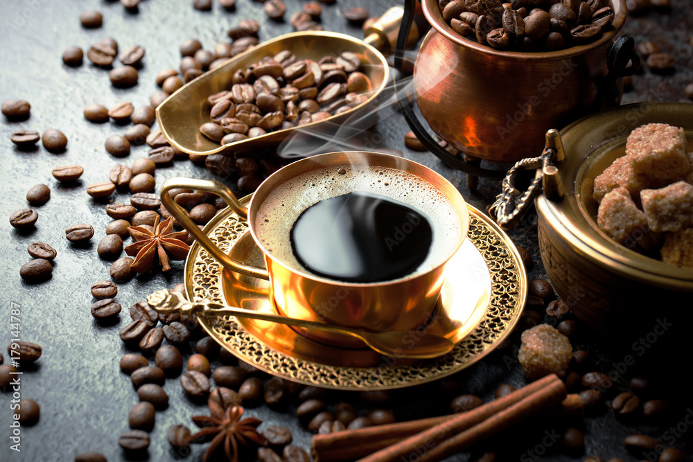 Black coffee in a cup on the table in a composition with coffee accessories on an old background Black coffee in a cup on the table in a composition with coffee accessories on an old background