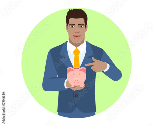 Businessman pointing at a piggy bank