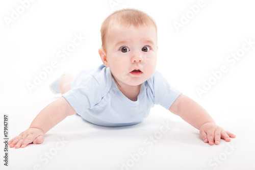 baby in the body lying on his stomach on a white background and looking at the camera © Ivan Traimak