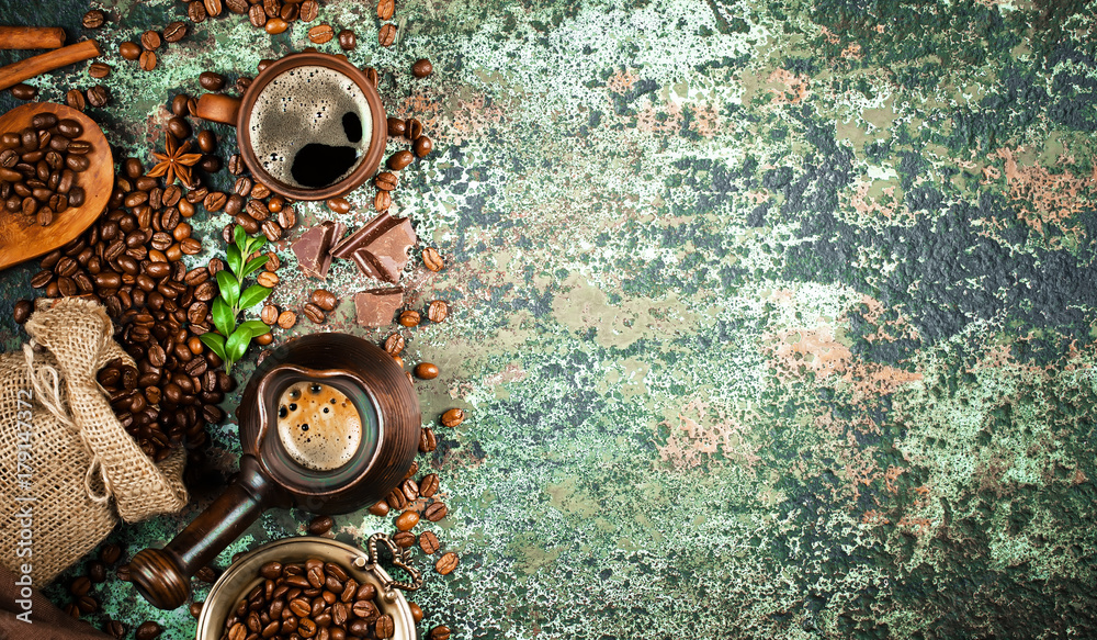 Black coffee in a cup on the table in a composition with coffee accessories on an old background Black coffee in a cup on the table in a composition with coffee accessories on an old background