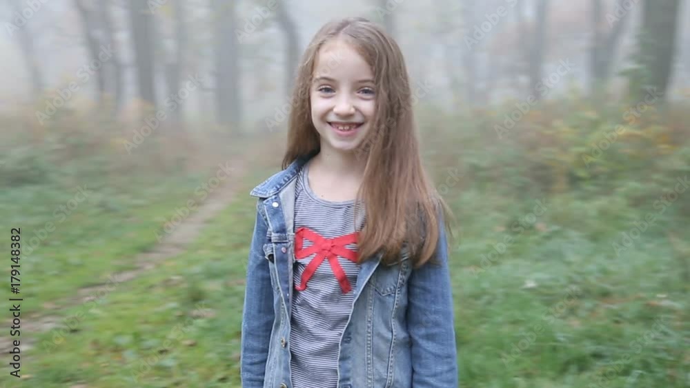 Adorable little girl turnes around and smiles in camera. Steadycam fly around shot. Adorable little girl turnes around and smiles in camera. Steadycam fly around shot.