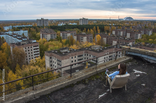 Girl seattingin Pripyat Chernobyl Zone  autumn time Chernobyl  Ukraine