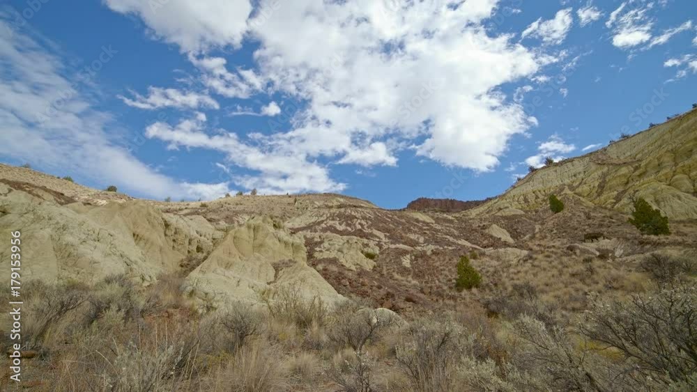 Badlands yellow clay John day fossil beds formations clouds and shadows drift over a remote desert mountain Sutton Mountain close to the Painted hills 10 Badlands yellow clay John day fossil beds formations clouds and shadows drift over a remote desert mountain Sutton Mountain close to the Painted hills 10