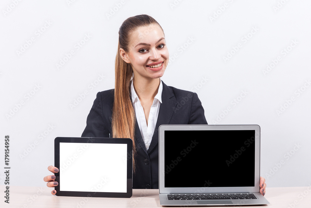 Picture of beautiful business lady showing PC and tablet computer Picture of beautiful business lady showing PC and tablet computer