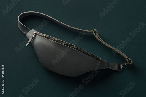 leather fanny pack on green background