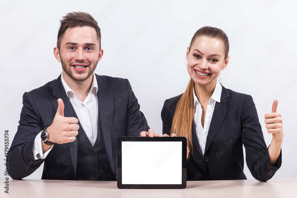 Picture of couple of office workers both holding tablet Picture of couple of office workers both holding tablet