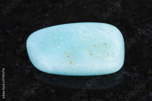 polished Aquamarine gemstone on dark