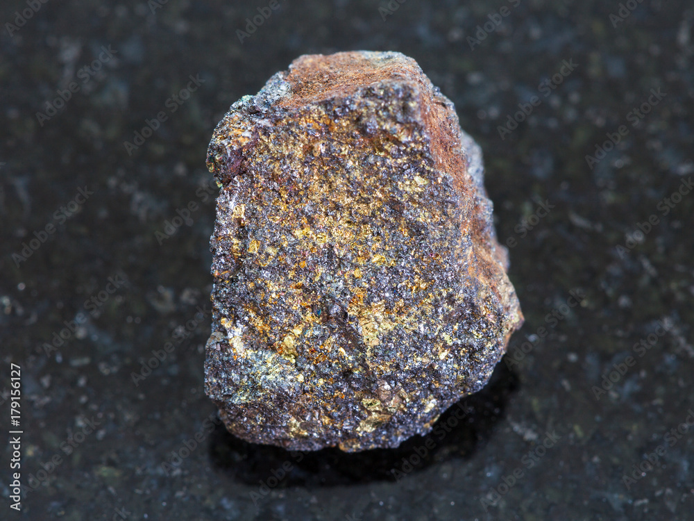 rough magnetite (iron ore) stone on dark rough magnetite (iron ore) stone on dark