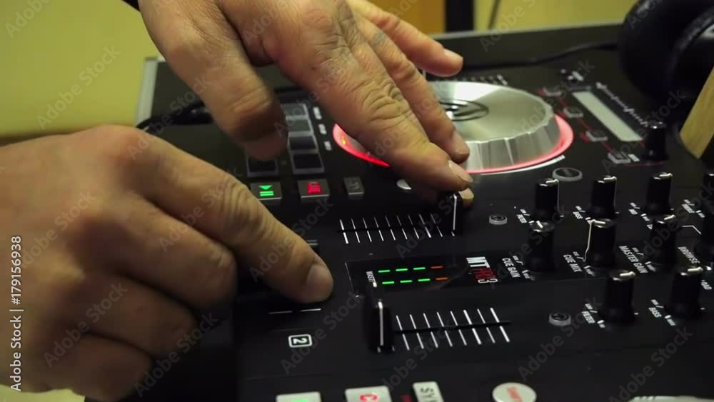 Closeup on male hands mixing music on mixing table. Mixing two musics together filmed in slow motion hd. Closeup on male hands mixing music on mixing table. Mixing two musics together filmed in slow motion hd.