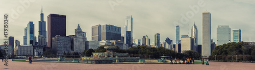 Buckingham Fountain, Millennium Park, Chicago Downtown. Tourists on segways. Cloudy day. High resolution panorama.