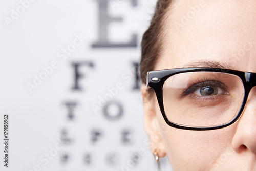 Girl in glasses on the background of a table for vision