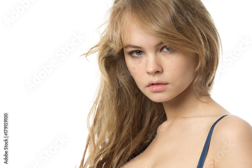 Beautiful blond young woman looks forward. Isolated on white.