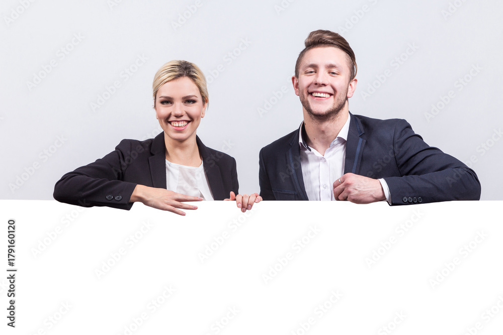 Picture of team of office workers stand near poster Picture of team of office workers stand near poster