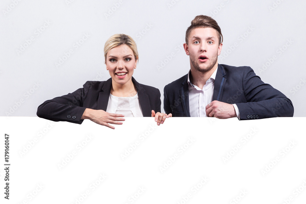 Picture of team of office workers stand near poster Picture of team of office workers stand near poster