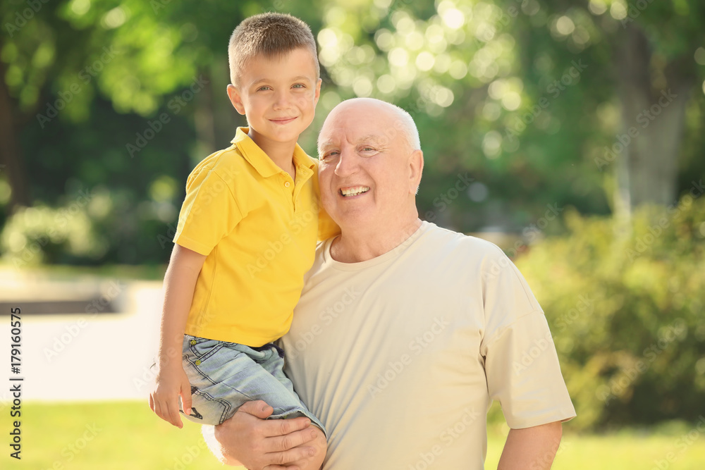 Happy senior man with grandson in park Happy senior man with grandson in park