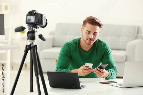 Young blogger recording vid...