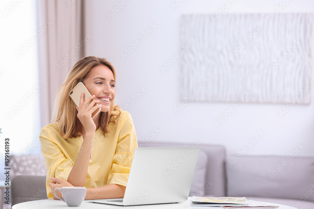 Beautiful young woman talking on mobile phone at home Beautiful young woman talking on mobile phone at home