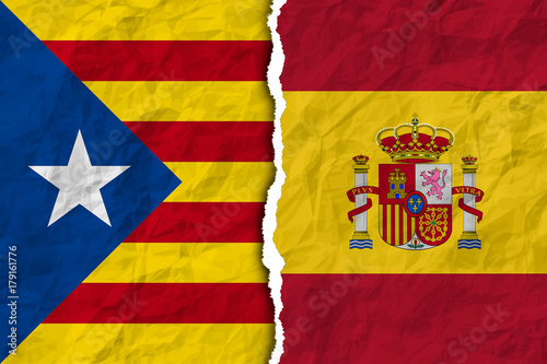 flags of spain and catalonia on torn paper texture