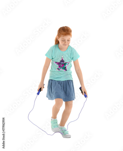 Cute little girl jumping rope on white background