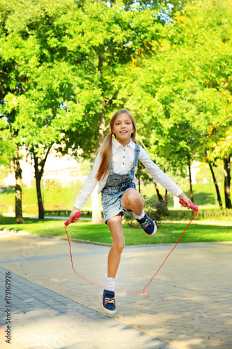 Cute little girl jumping ro...