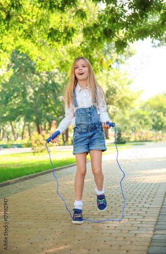 Cute little girl jumping ro...