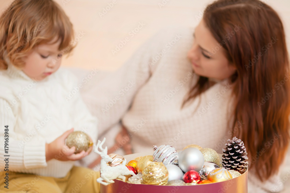 Mother and child decorating home for Christmas.